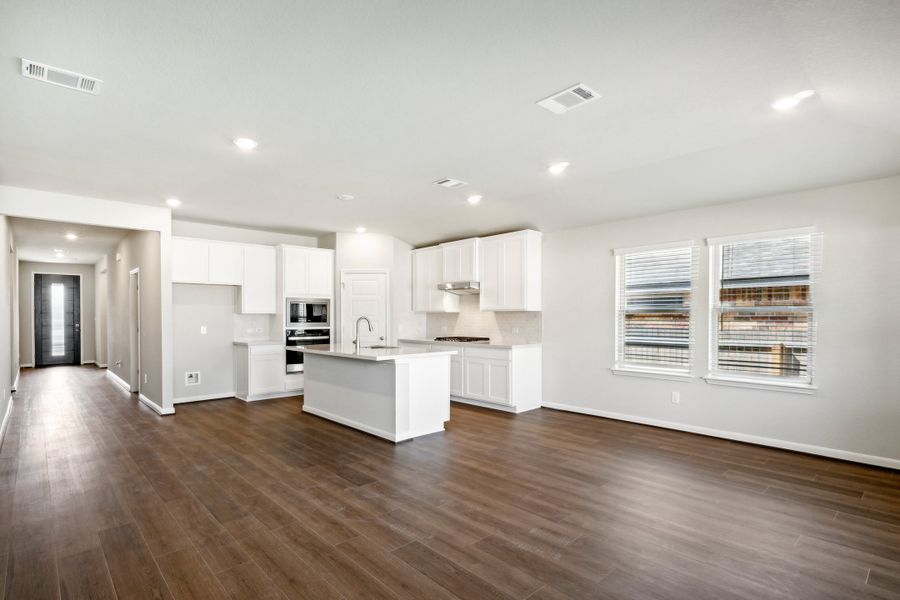 Dining room and kitchen in the Fitzhugh floorplan in a Meritage Homes community.