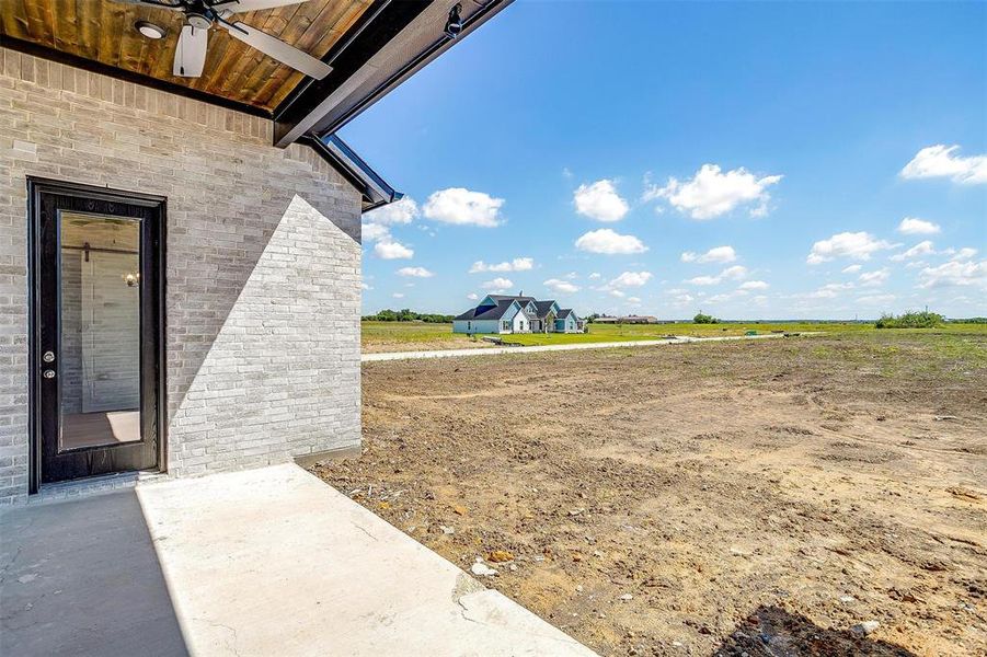 View of yard featuring ceiling fan