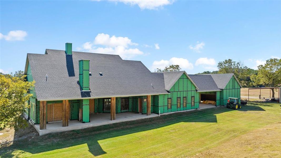 Rear view of property with a patio area and a lawn