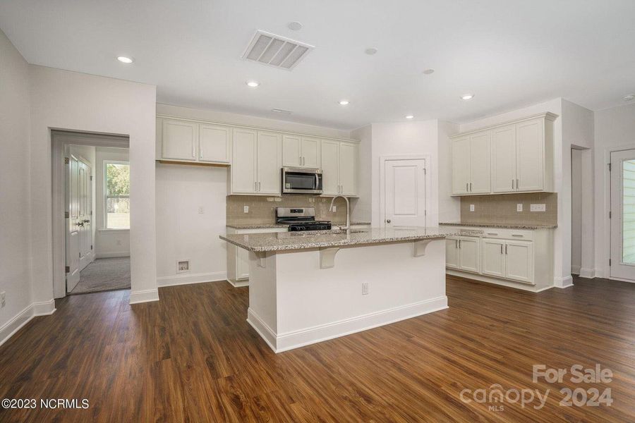 Concept photo of Upgraded Kitchen with granite counters, stainless steel appliances, large center island with seating, pantry, recessed lights & plenty of cabinets for storage!