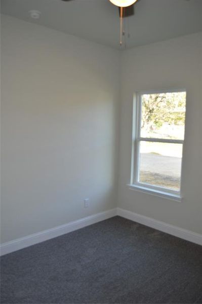 Carpeted bedroom with ceiling fan