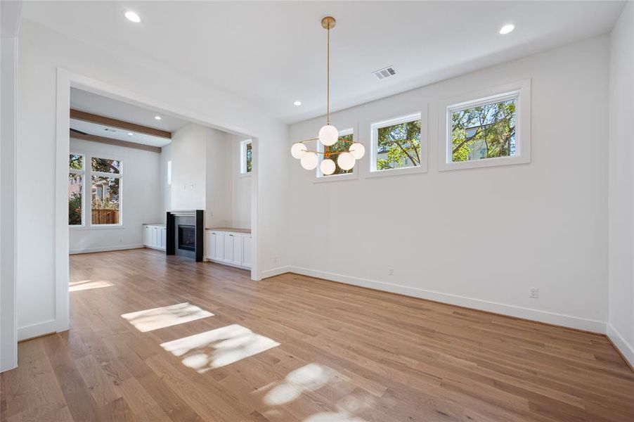 View from dining room into great room. Lots of natural light and beautiful tree views.