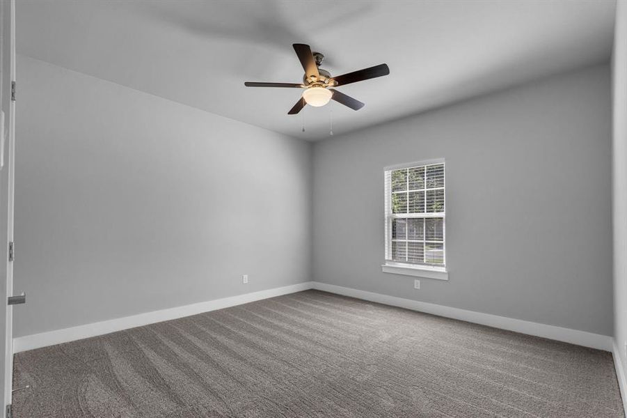 Unfurnished room with ceiling fan and carpet floors