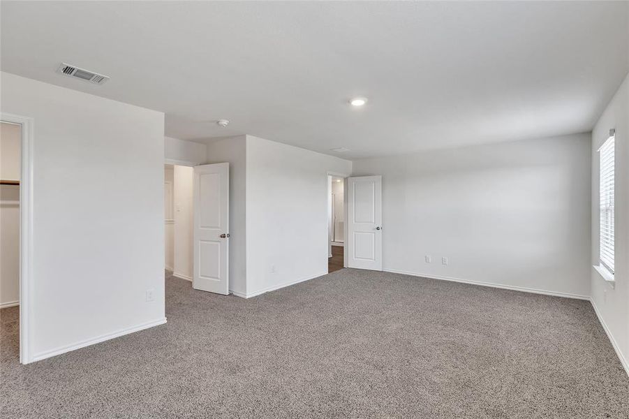Large primary bedroom with dual walk in closets