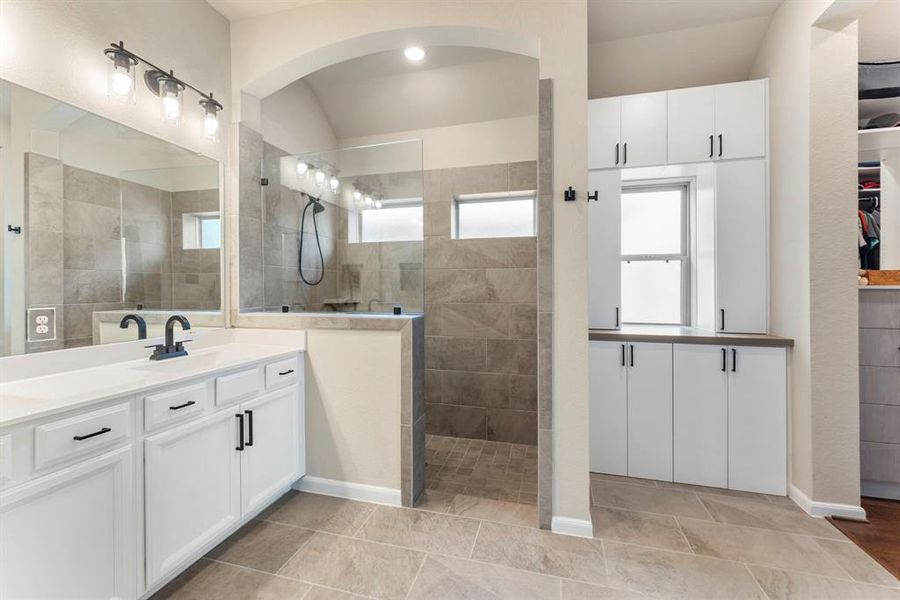 Very spacious primary bathroom. You have to see the size of the closet and the built ins. There is also a TV in the bathroom.