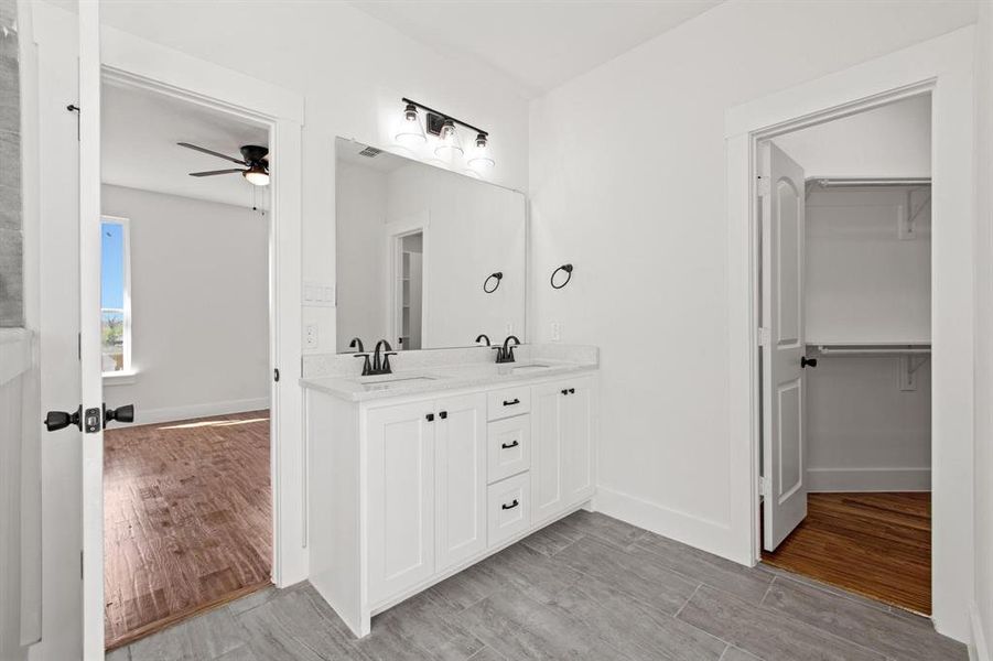 Bathroom with vanity, ceiling fan, and hardwood / wood-style floors