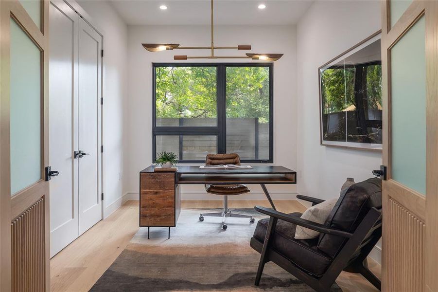 Just off the foyer sits a dedicated office with a grand set of custom stained white oak doors. The ideal place to work from home, it is also home to the centralized AV closet for maximum connectivity....