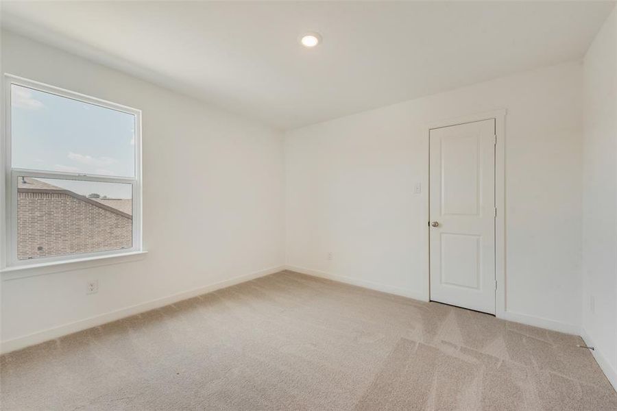 Unfurnished room with light carpet