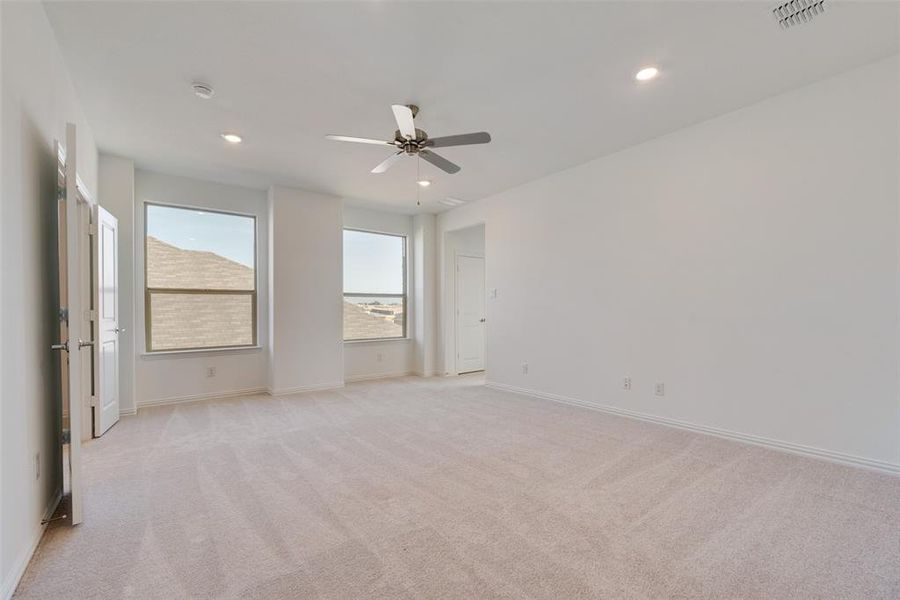 Unfurnished room featuring light carpet and ceiling fan