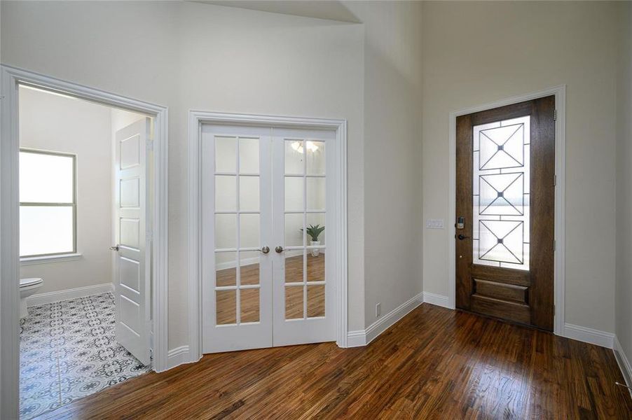 Foyer featuring french doors and wood-type flooring