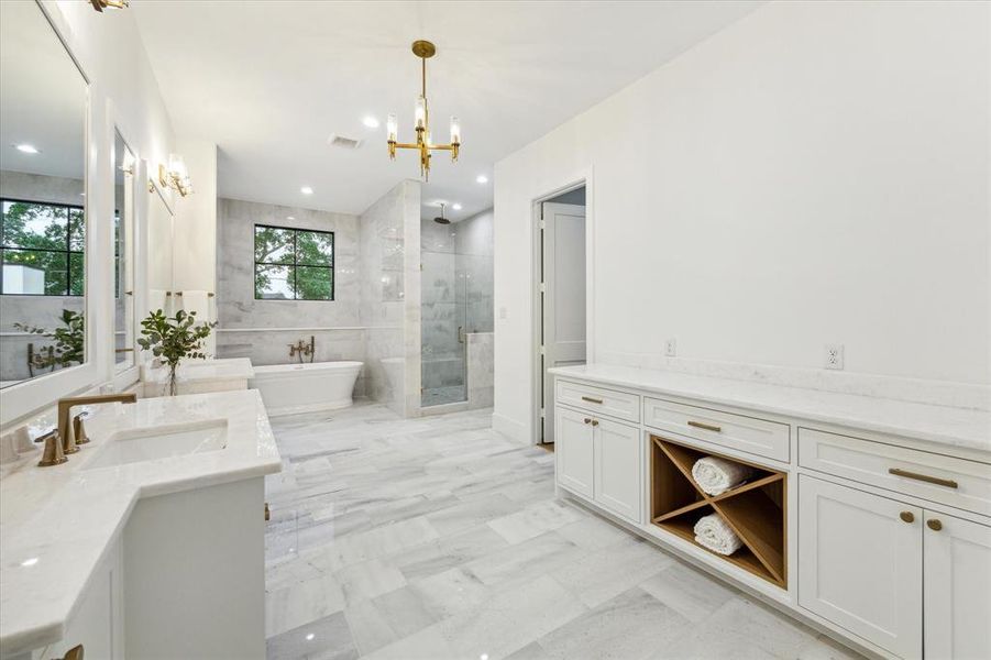 Abundance of storage and counter space in this exceptional bath.  The custom storage to the right of this picture is the perfect spot for your morning coffee bar!