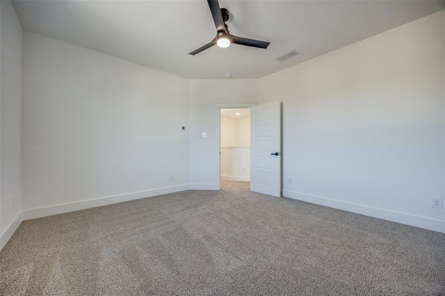 Spare room with carpet floors and ceiling fan