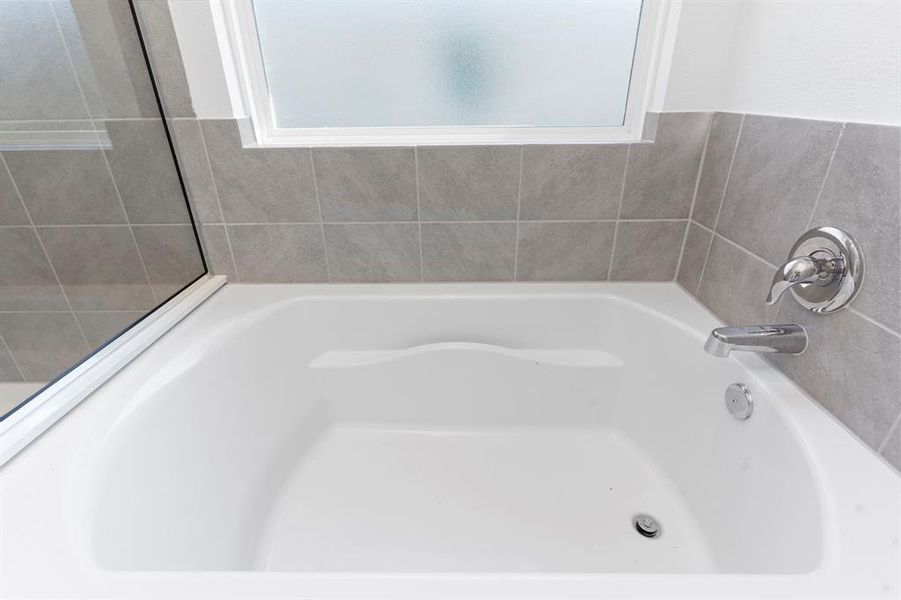 Deep Soaker Tub with arm rest to bubble away!  Frosted Glass Insulated windows. **Representative Photo of Plan only and may vary as built**