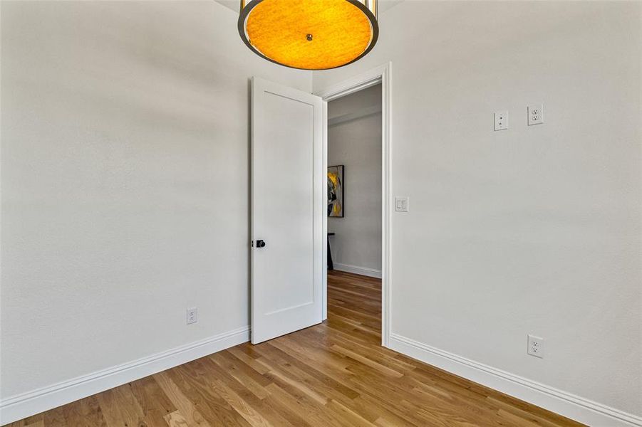 Empty room with light hardwood / wood-style floors