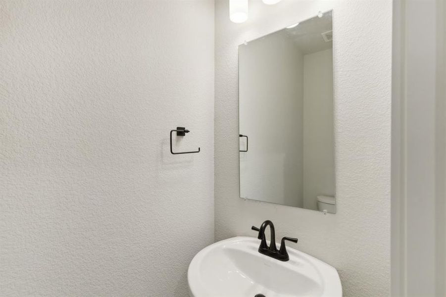 Bathroom featuring sink and toilet