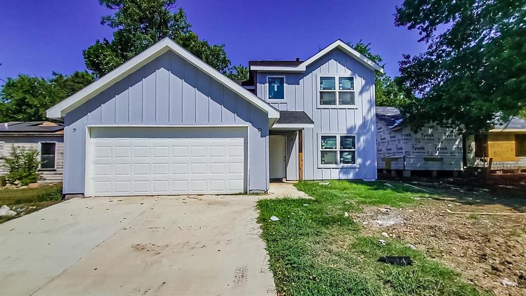 View of front facade featuring a garage