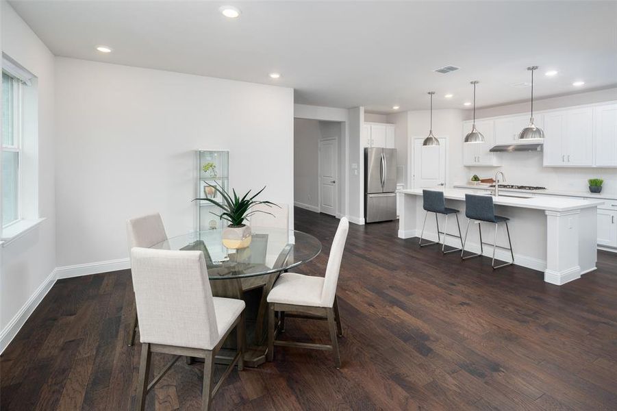 Dining room with dark wood-type flooring