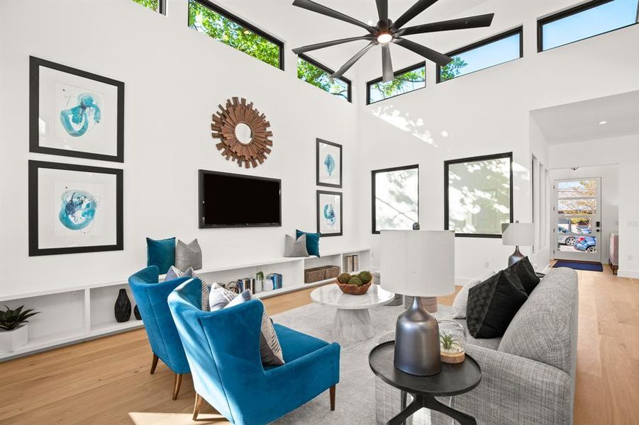 The living room is infused with peaceful natural light during the daytime with views of the starry skies at night through the tall clerestory windows that wrap around the exterior walls.