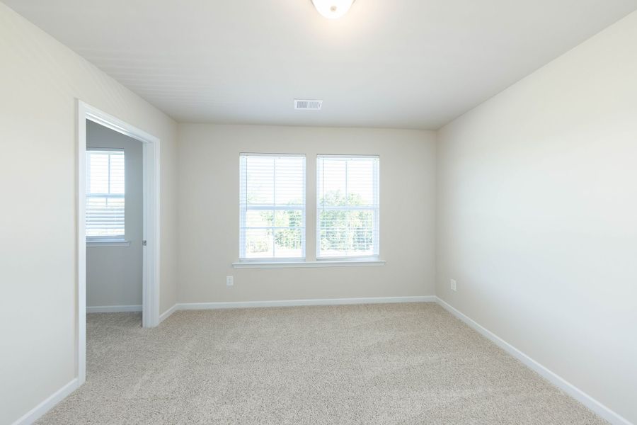 Open and bright second level bedroom with walk-in closet