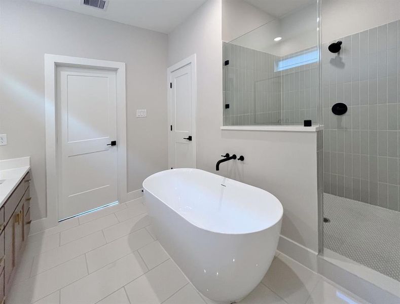 Ensuite Oasis: Modern, sleek design with a luxurious freestanding tub and spacious glass-enclosed shower.