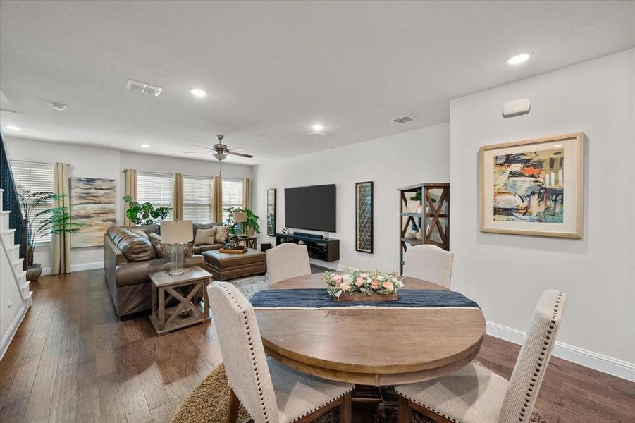 Dining space featuring ceiling fan and dark hardwood / wood-style flooring