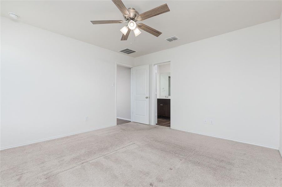 Spare room with ceiling fan and carpet flooring