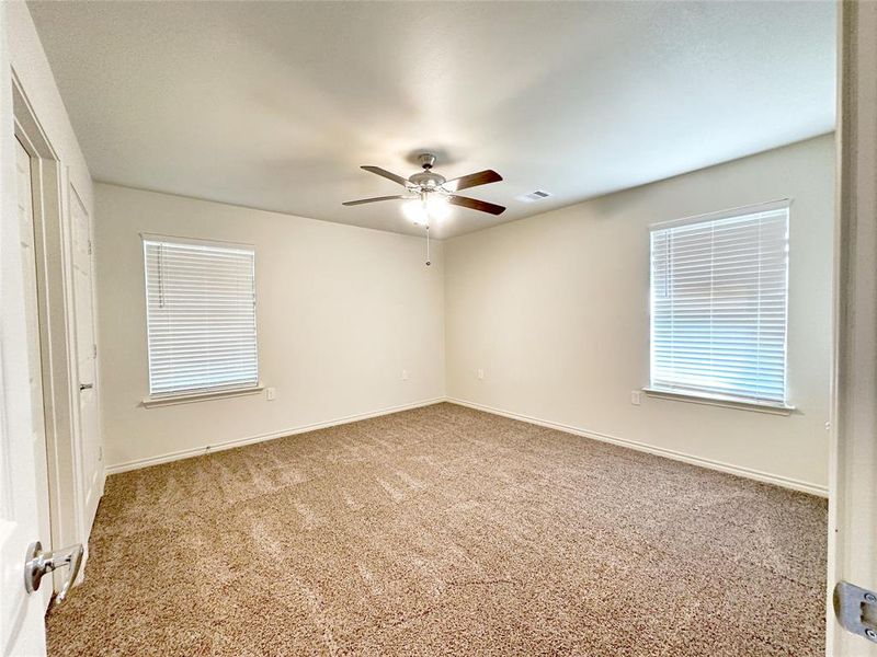 Carpeted empty room with ceiling fan