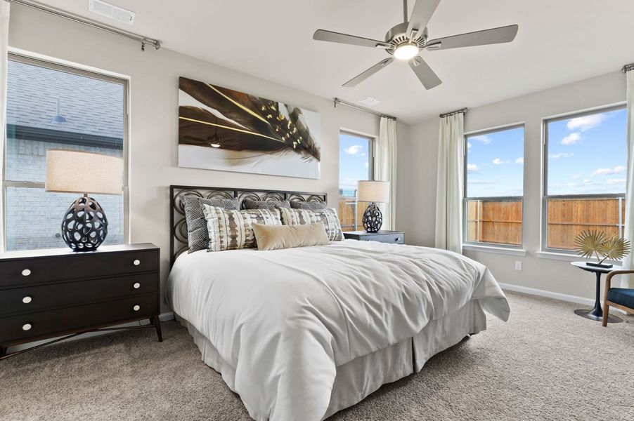 Primary bedroom in the Wimbledon home plan by Trophy Signature Homes – REPRESENTATIVE PHOTO