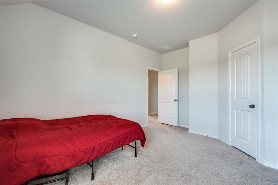 Carpeted bedroom with vaulted ceiling