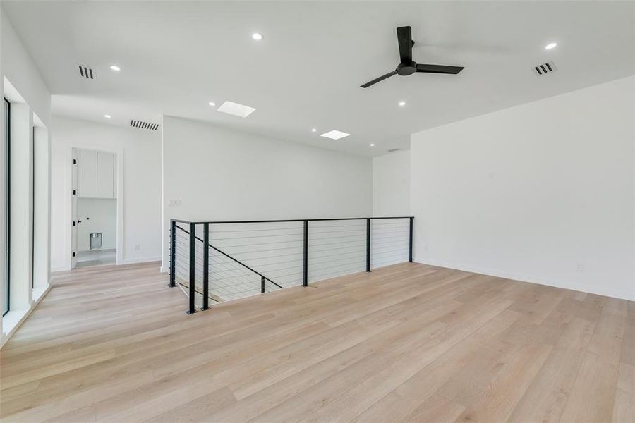 Empty room featuring light hardwood / wood-style floors and ceiling fan