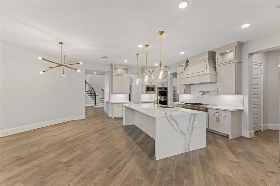 -- Representational Photo -- Chic Chef's Kitchen with luxurious finishes and large island open to the Breakfast Area perfect for entertaining in style.