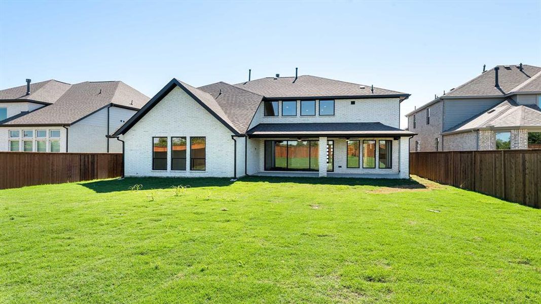 Back of house featuring a patio area and a lawn