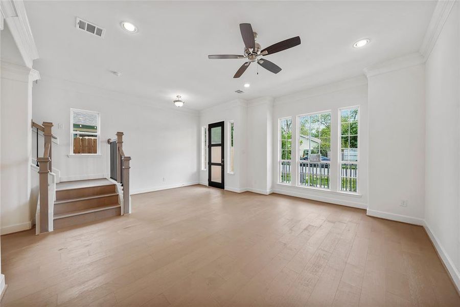 Imagine hosting family and friends in this spacious living area! The wood flooring in the living area is part of our Standard Features. (Sample photos of a completed Gibraltar floor plan. The image may feature alternative selections and/or upgrades.)