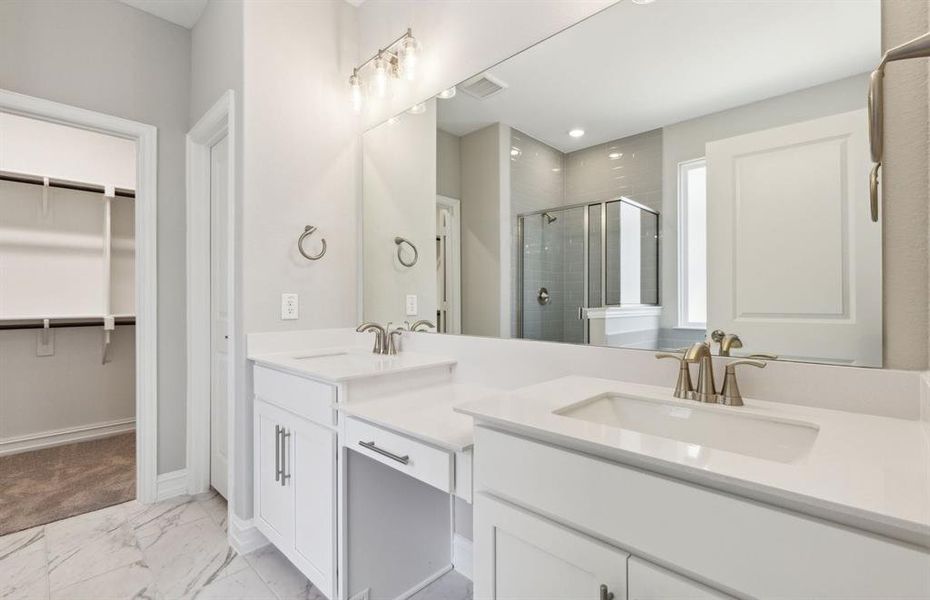 Elegant owner's bath with dual vanity *real home pictured