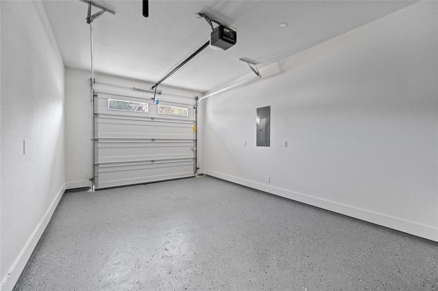 Garage with a garage door opener and electric panel