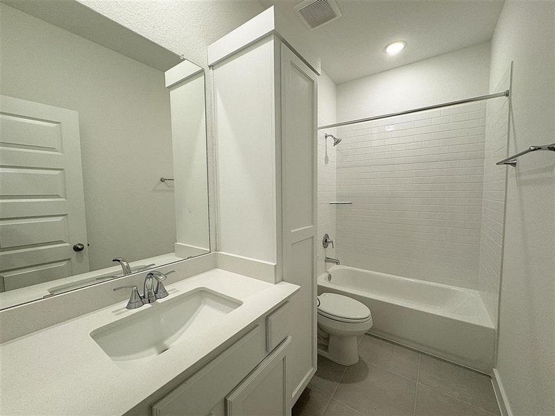 In between the bedrooms, there is a bathroom with extra storage