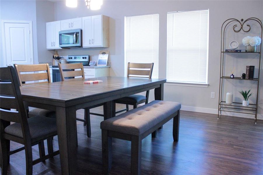 Dining area with dark wood-type flooring