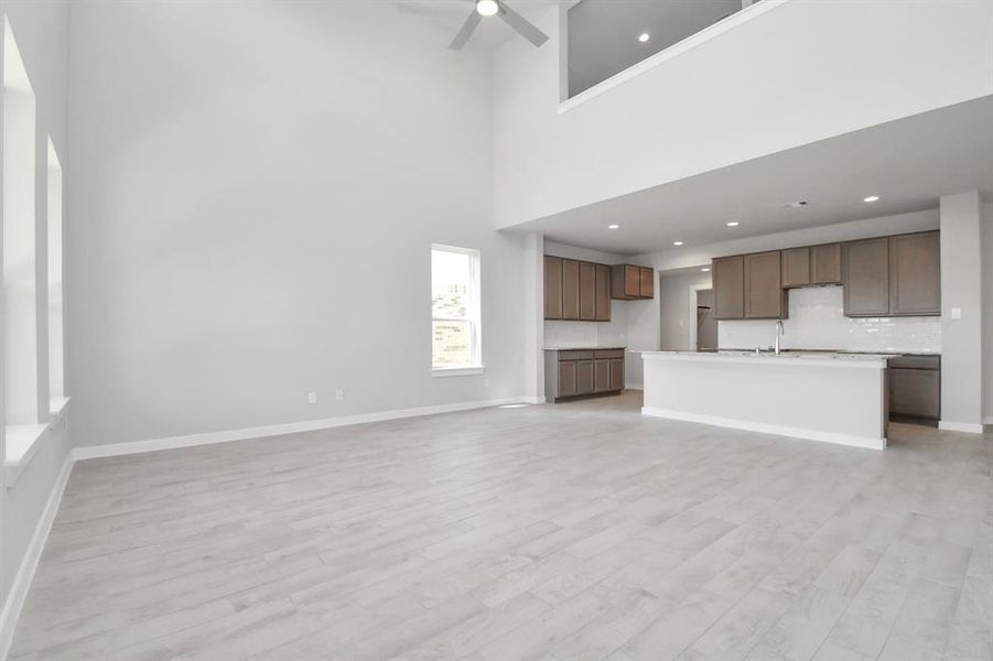 Take another glimpse into the heart of the home with this additional view of the family room—a sprawling space ready to accommodate all your gatherings. Sample photo of completed home. Actual colors and selections may vary.