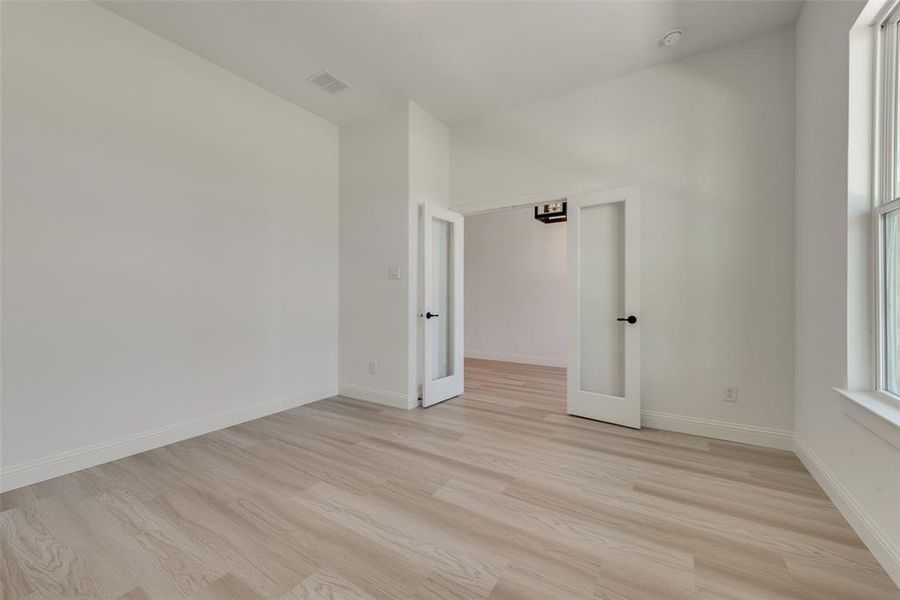 Empty room with light hardwood / wood-style flooring