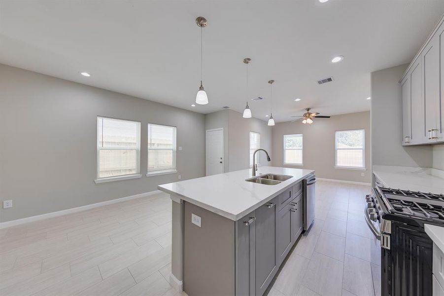 Elegantly accented by modern pendant lights, this island serves as both a functional workspace and a beautiful focal point, perfect for gathering and entertaining.