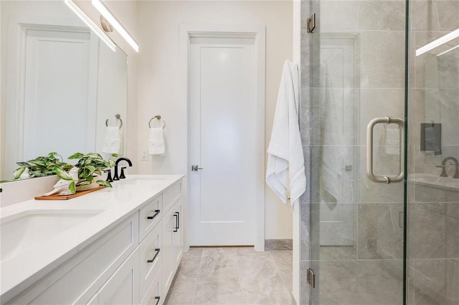 Bathroom with a shower with shower door and vanity