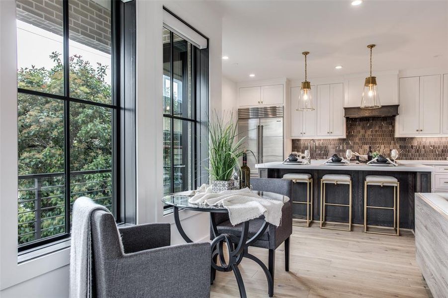 Kitchen featuring light hardwood / wood floors, white cabinetry, and a wealth of natural light