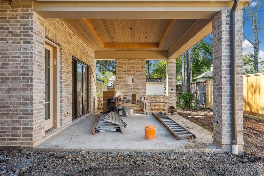 Expansive pavilion with high ceilings, T&G wood ceiling, summer kitchen w/ grill, sink and refrigerator. The fence will be completed to match the new fence in the back.