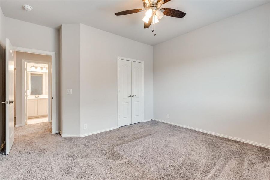 Unfurnished bedroom with light carpet, a closet, and ceiling fan