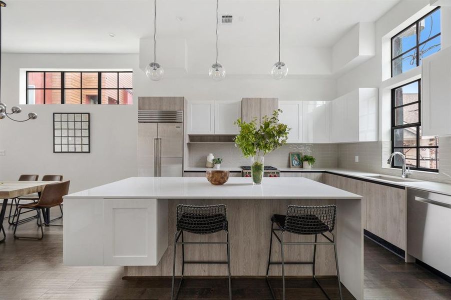 Soft-close cabinets create a serene kitchen atmosphere, while under-cabinet lighting enhances both functionality and ambiance.