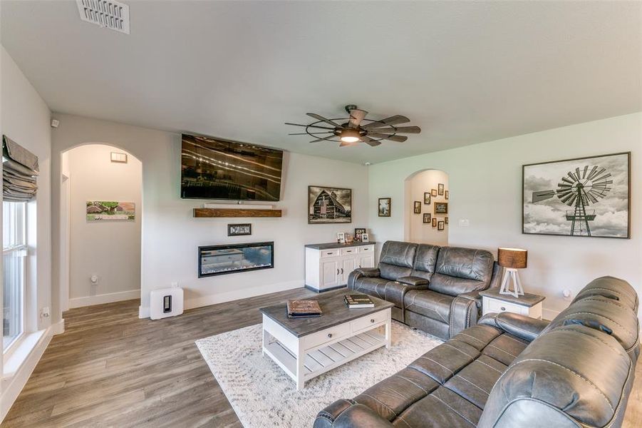 Living room featuring ceiling fan and light hardwood / wood-style flooring