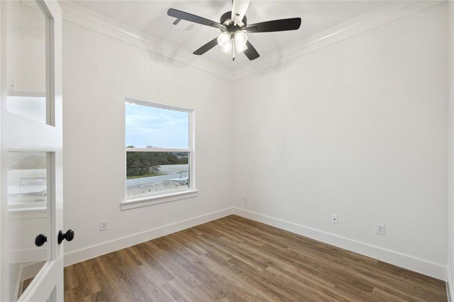 Unfurnished room with ornamental molding, ceiling fan, and hardwood / wood-style floors