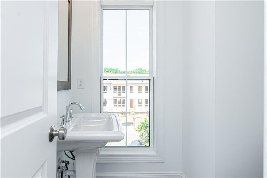 Half Bath located behind the Kitchen  with a healthy amount of sunlight, not the actual unit