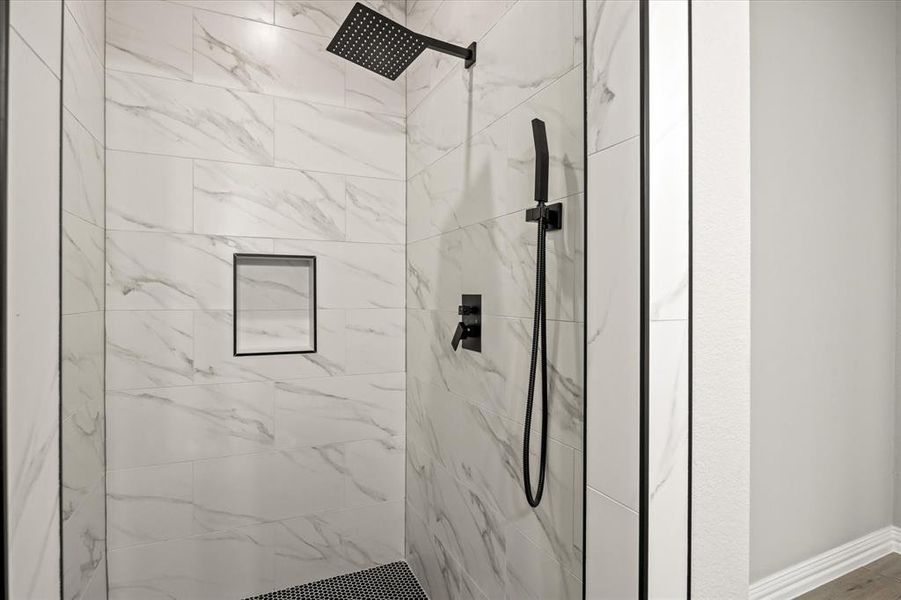 Primary bathroom featuring tiled shower