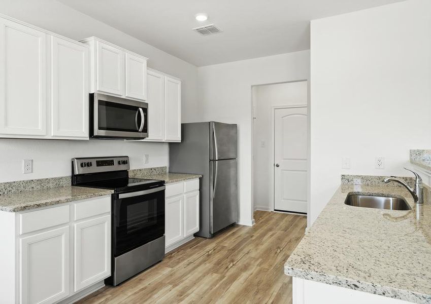 White cabinets and grey granite countertops in the kitchen